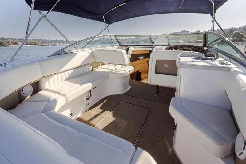 Cobalt Yacht Photos Pics 2008 Cobalt 303 boat interior with white seating and blue canopy on a sunny day.