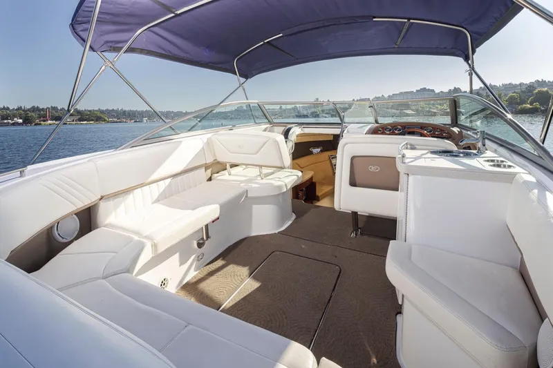 Cobalt Yacht Photos Pics 2008 Cobalt 303 boat interior with white seating and blue canopy on a sunny day.
