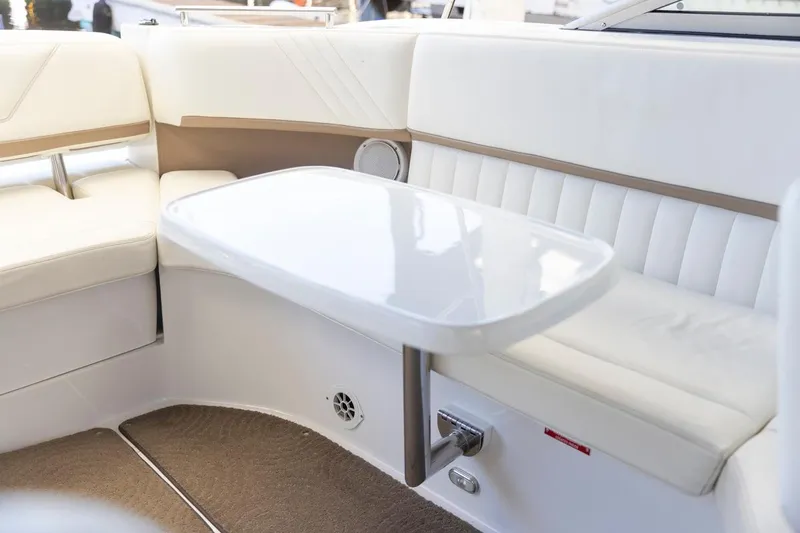 Cobalt Yacht Photos Pics Interior seating and table of a 2008 Cobalt 303 boat with white upholstery.