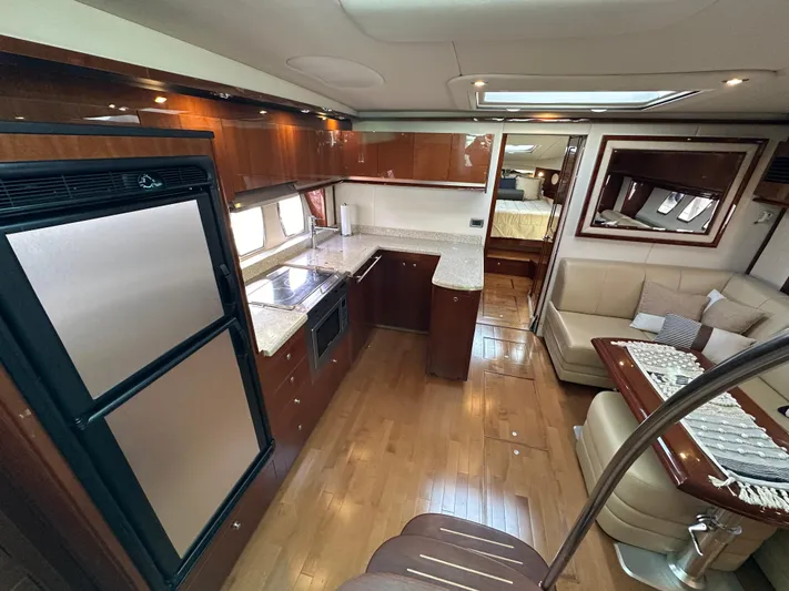  Yacht Photos Pics Luxurious interior of 2009 Sea Ray 48 Sundancer yacht with modern kitchen and seating area.
