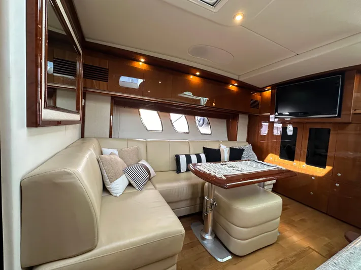  Yacht Photos Pics Luxurious interior of 2009 Sea Ray 48 Sundancer yacht with plush seating and elegant wood finishes.