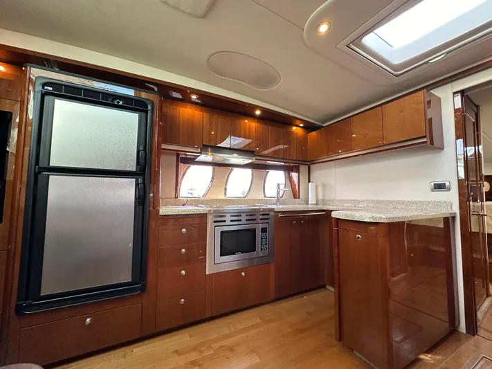  Yacht Photos Pics Luxurious kitchen interior of 2009 Sea Ray 48 Sundancer yacht with modern appliances.