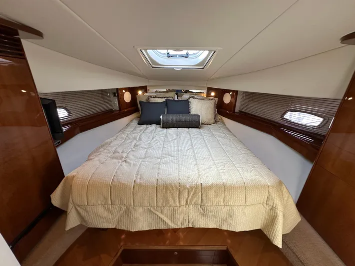  Yacht Photos Pics Luxurious bedroom interior of 2009 Sea Ray 48 Sundancer yacht with skylight and elegant bedding.