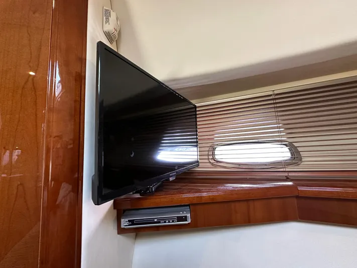  Yacht Photos Pics Flat-screen TV in 2009 Sea Ray 48 Sundancer yacht interior with wooden paneling.