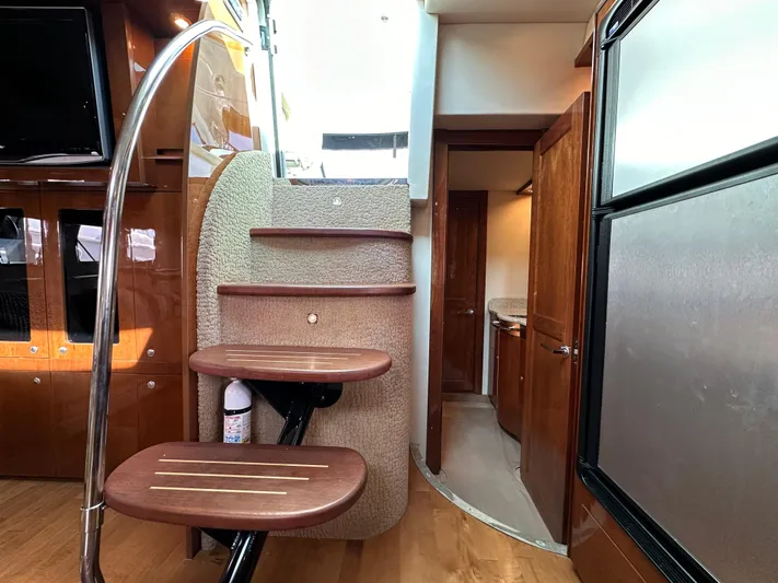  Yacht Photos Pics Interior of 2009 Sea Ray 48 Sundancer yacht with modern staircase and wooden finishes.