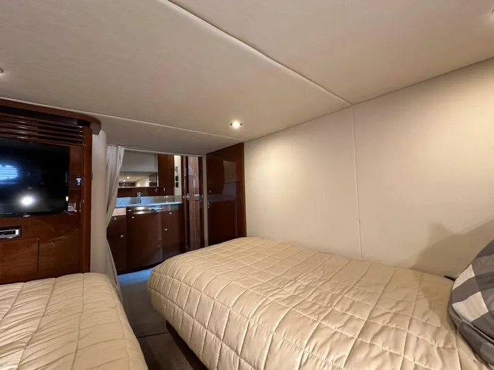  Yacht Photos Pics Interior cabin of 2009 Sea Ray 48 Sundancer yacht with twin beds and modern decor.