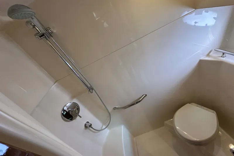  Yacht Photos Pics Bathroom interior of 2009 Sea Ray 48 Sundancer yacht, featuring shower and toilet.