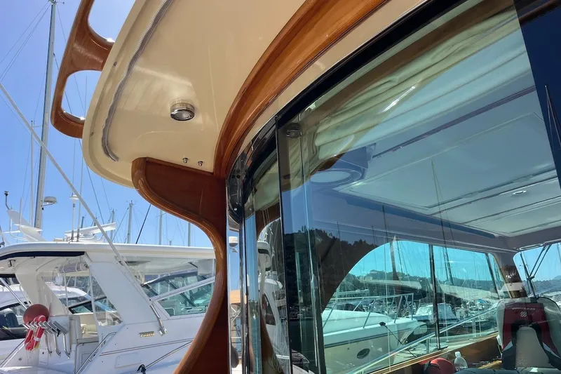 Cassidy Yacht Photos Pics 2013 Hinckley Talaria 48 MY yacht with sleek design and reflective windows in a marina.