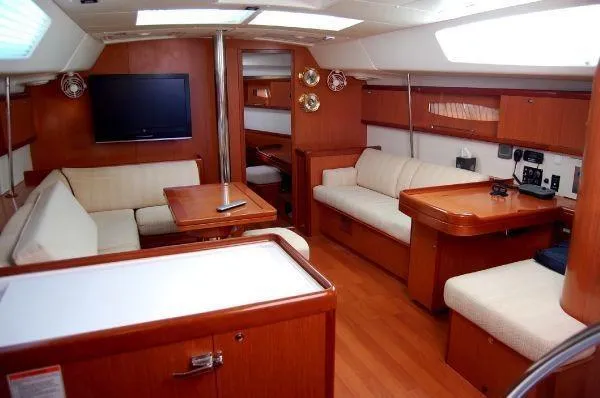 Le Reve Yacht Photos Pics Luxurious interior of 2008 Beneteau Oceanis 49 yacht with wood finish and comfortable seating.