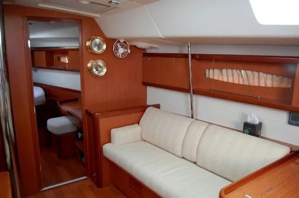 Le Reve Yacht Photos Pics Interior of 2008 Beneteau Oceanis 49 yacht with cozy seating and wooden finishes.