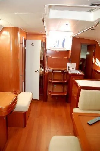 Le Reve Yacht Photos Pics Interior of 2008 Beneteau Oceanis 49 yacht with wooden furnishings and seating area.