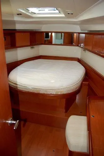 Le Reve Yacht Photos Pics Interior cabin of 2008 Beneteau Oceanis 49 yacht with wooden furnishings and a skylight.