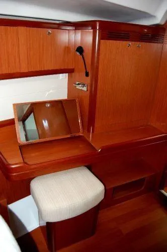 Le Reve Yacht Photos Pics 2008 Beneteau Oceanis 49 yacht interior with wooden vanity and cushioned stool.