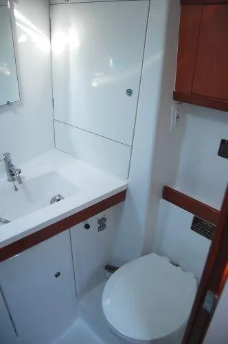 Le Reve Yacht Photos Pics Bathroom interior of 2008 Beneteau Oceanis 49 yacht, featuring sink and toilet.