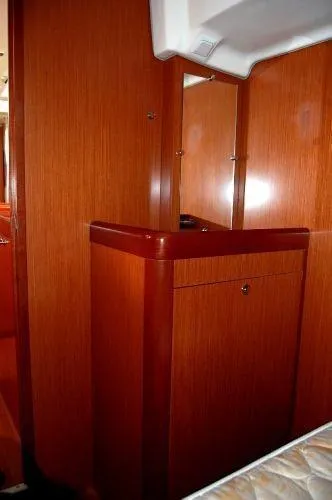 Le Reve Yacht Photos Pics Interior of 2008 Beneteau Oceanis 49 yacht with wooden cabinetry and mirror.