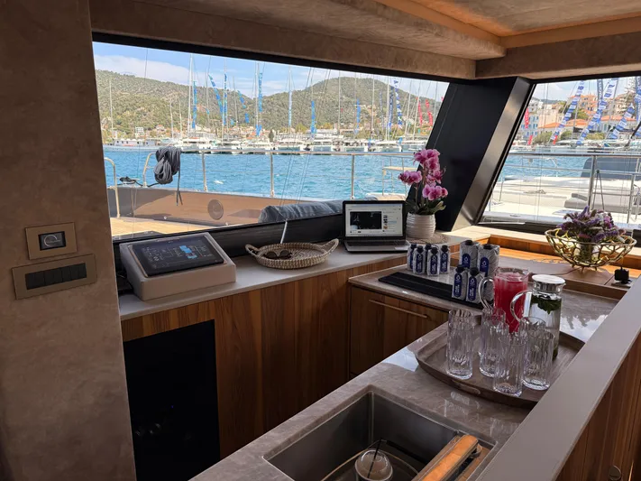 2026 Moon 60 Sail New Yacht Photos Pics Luxurious interior of 2026 Moon 60 Sail yacht with scenic marina view.