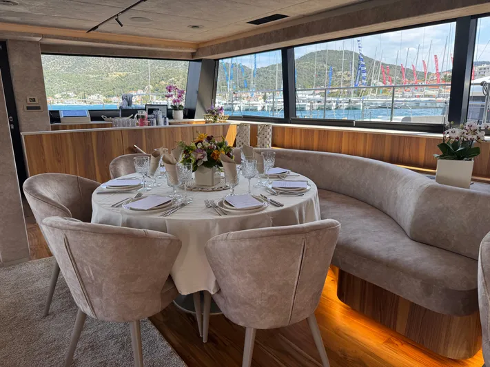 2026 Moon 60 Sail New Yacht Photos Pics Luxurious dining area on 2026 Moon 60 Sail yacht with elegant table setting.