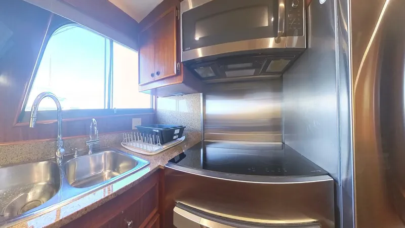 Carry On Yacht Photos Pics Modern kitchen in 1982 Hatteras 65 LRC yacht with stainless steel appliances.