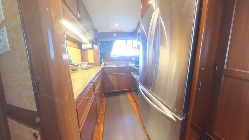 Carry On Yacht Photos Pics Luxurious kitchen interior of 1982 Hatteras 65 LRC yacht with modern appliances.
