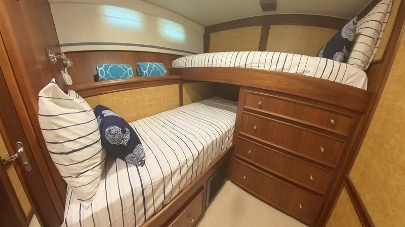 Carry On Yacht Photos Pics Cozy 1982 Hatteras 65 LRC cabin with bunk beds and striped bedding.