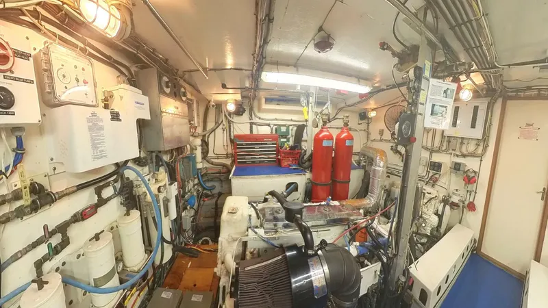 Carry On Yacht Photos Pics Engine room of 1982 Hatteras 65 LRC yacht, featuring equipment and control panels.