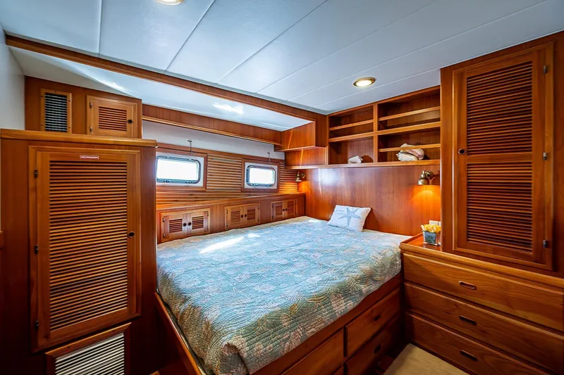  Yacht Photos Pics Luxurious 2012 Kadey-Krogen Krogen 42 Trawler bedroom with wood cabinetry and cozy bedding.