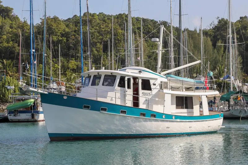  Yacht Photos Pics 2012 Kadey-Krogen Krogen 42 Trawler docked in a scenic marina.