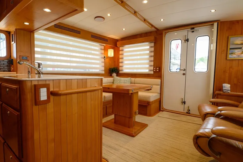  Yacht Photos Pics Luxurious interior of 2012 Kadey-Krogen Krogen 42 Trawler with wood finishes and cozy seating.