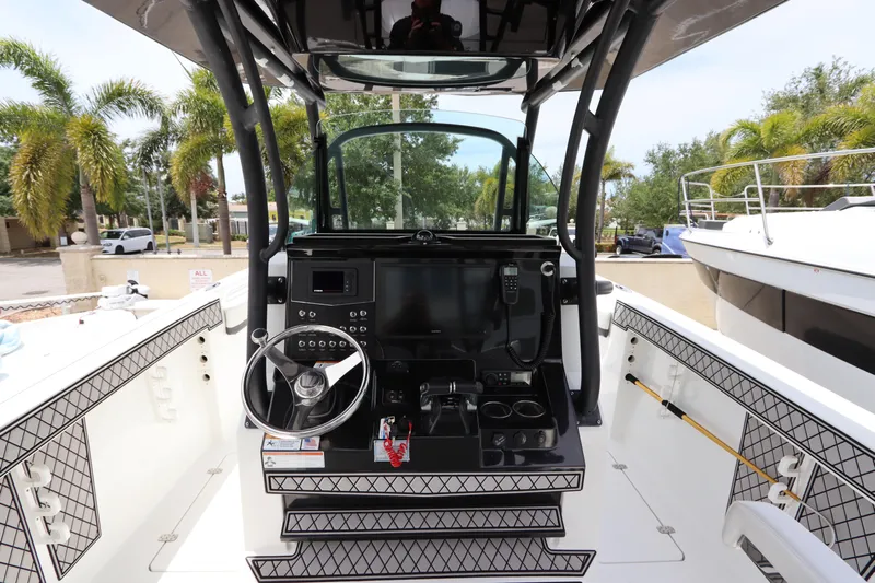  Yacht Photos Pics 2020 Wellcraft 302 Fisherman boat cockpit with steering wheel and control panel.