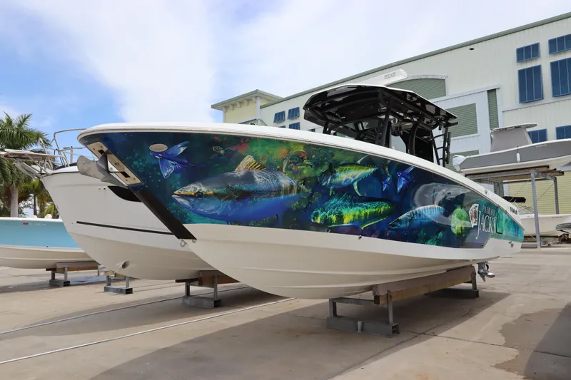 Yacht Photos Pics 2020 Wellcraft 302 Fisherman boat with vibrant fish-themed hull design.