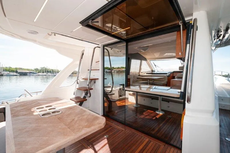 Steel Dreamin Yacht Photos Pics 2022 Greenline 45 Fly yacht interior with hardtop, solar panels, and elegant wooden deck.