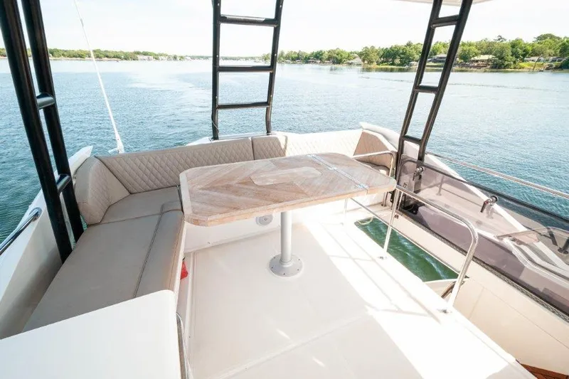 Steel Dreamin Yacht Photos Pics Luxurious 2022 Greenline 45 Fly yacht with hardtop, solar panels, and elegant seating area.