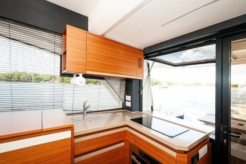 Steel Dreamin Yacht Photos Pics Modern kitchen interior of 2022 Greenline 45 Fly yacht with sleek wood cabinetry.