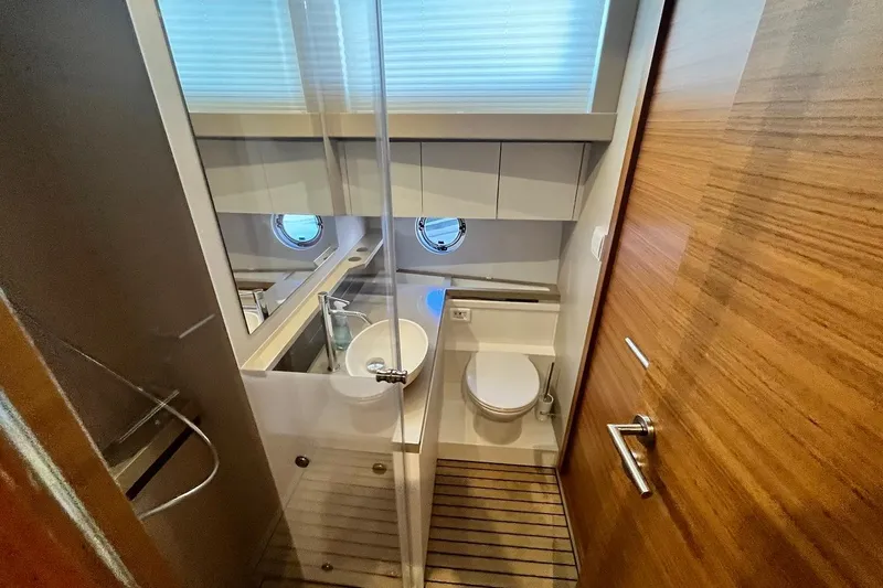 Steel Dreamin Yacht Photos Pics Luxurious bathroom in 2022 Greenline 45 Fly yacht with modern fixtures and wooden accents.