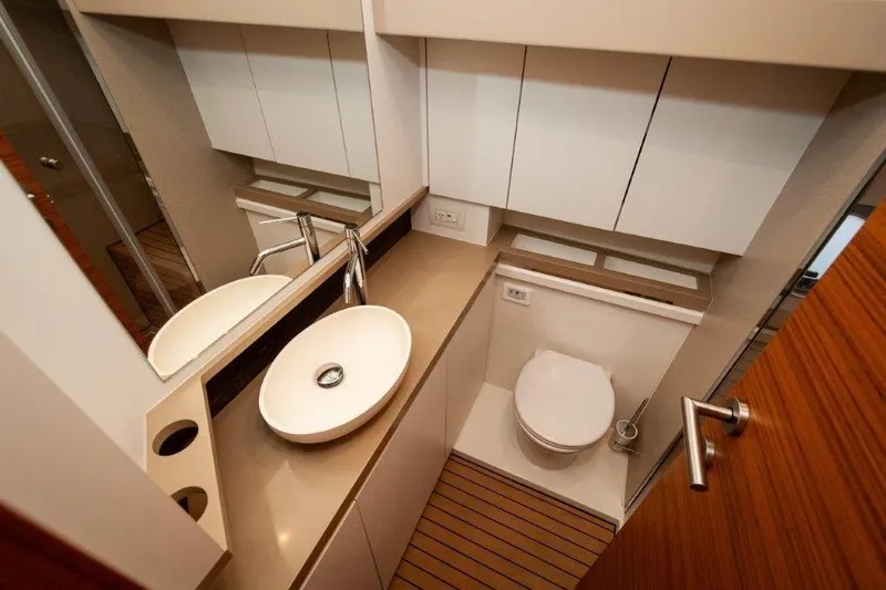 Steel Dreamin Yacht Photos Pics Modern yacht bathroom with sleek sink, toilet, and wooden flooring on Greenline 45 Fly, 2022.