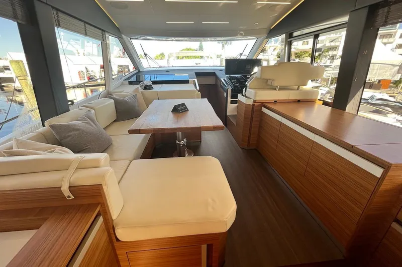 Steel Dreamin Yacht Photos Pics Luxurious interior of 2022 Greenline 45 Fly yacht with modern seating and wooden finishes.
