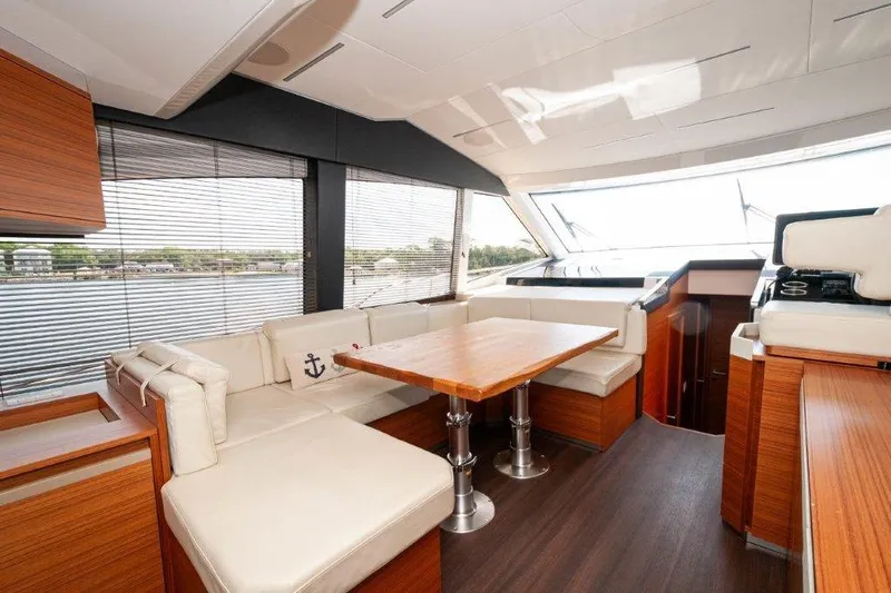 Steel Dreamin Yacht Photos Pics Luxurious interior of 2022 Greenline 45 Fly yacht with elegant seating and wooden finishes.