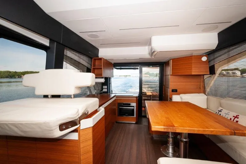 Steel Dreamin Yacht Photos Pics Luxurious interior of 2022 Greenline 45 Fly yacht with modern wood finishes and scenic water view.