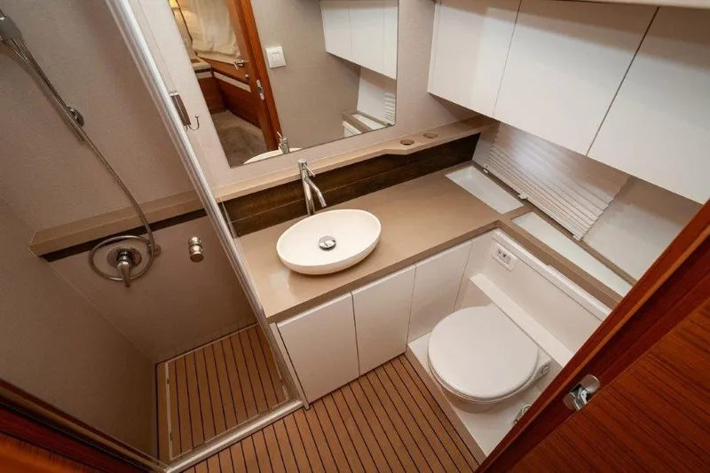 Steel Dreamin Yacht Photos Pics Luxurious bathroom in 2022 Greenline 45 Fly yacht with modern fixtures and wooden flooring.