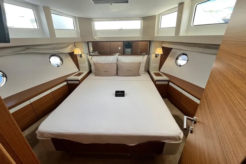 Steel Dreamin Yacht Photos Pics Luxurious cabin interior of 2022 Greenline 45 Fly yacht, featuring elegant wood finishes and ample natural light.