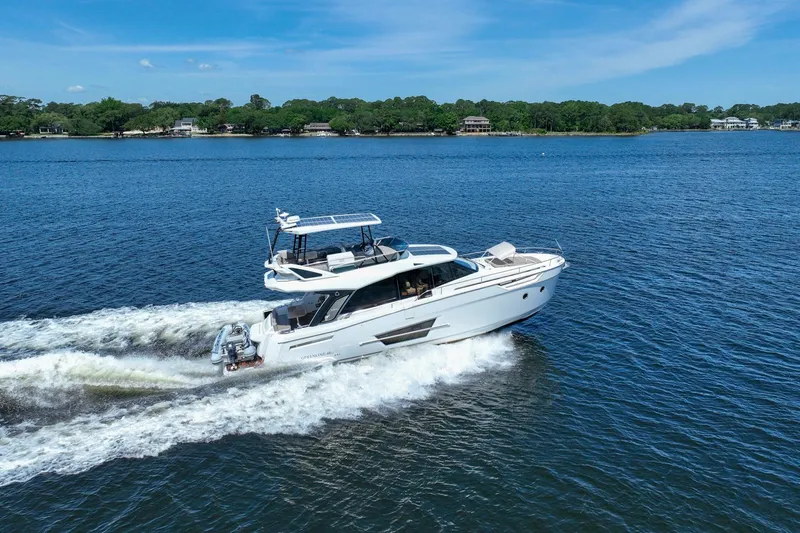 Steel Dreamin Yacht Photos Pics 2022 Greenline 45 Fly yacht with hardtop and solar panels cruising on a serene lake.