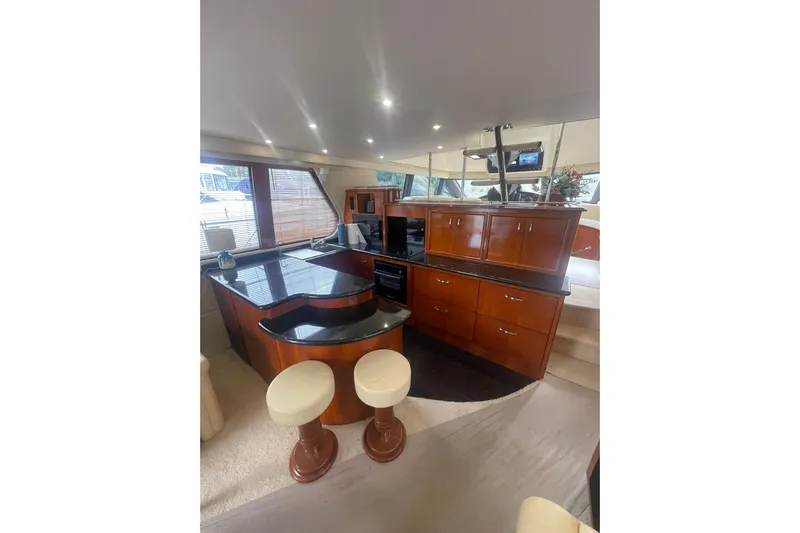 Sea Spirit Yacht Photos Pics Luxurious interior of 2004 Carver 570 Voyager Pilothouse with elegant wood cabinetry and modern amenities.