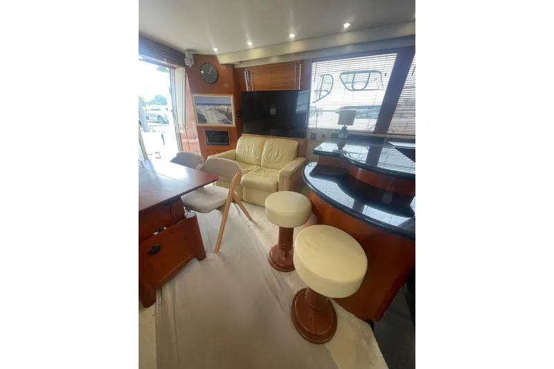 Sea Spirit Yacht Photos Pics Luxurious interior of 2004 Carver 570 Voyager Pilothouse with seating and bar area.