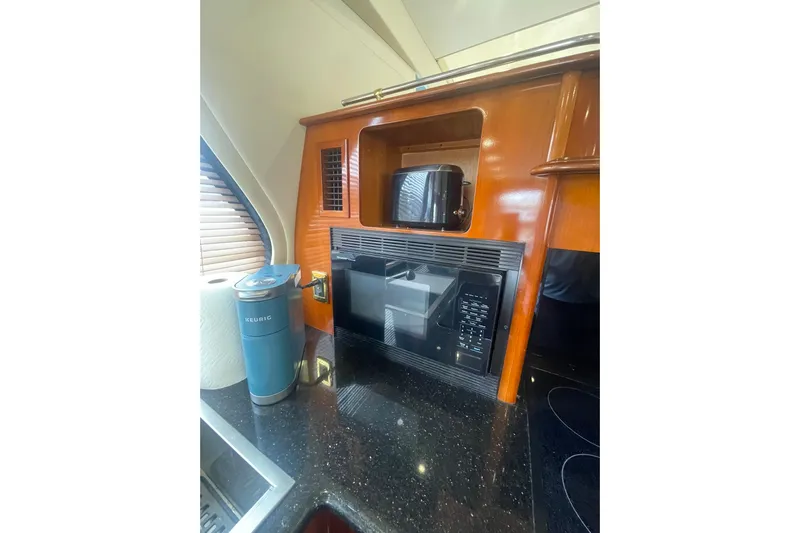 Sea Spirit Yacht Photos Pics 2004 Carver 570 Voyager Pilothouse kitchen with microwave, toaster, and Keurig coffee maker.