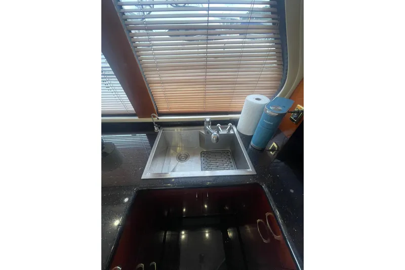 Sea Spirit Yacht Photos Pics Kitchen sink area in 2004 Carver 570 Voyager Pilothouse with blinds and countertop items.