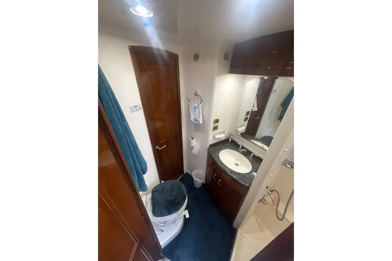 Sea Spirit Yacht Photos Pics Bathroom interior of 2004 Carver 570 Voyager Pilothouse with sink, toilet, and mirror.