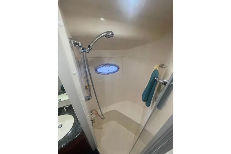 Sea Spirit Yacht Photos Pics Shower area in 2004 Carver 570 Voyager Pilothouse yacht with porthole and handheld showerhead.