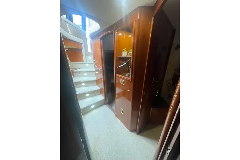Sea Spirit Yacht Photos Pics Interior of 2004 Carver 570 Voyager Pilothouse with elegant wood finish and carpeted stairs.
