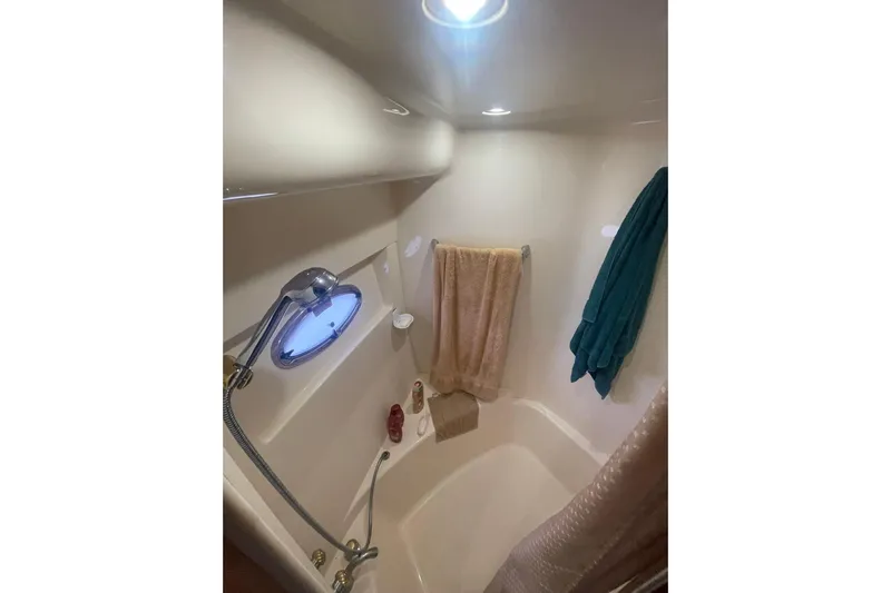 Sea Spirit Yacht Photos Pics Bathroom interior of 2004 Carver 570 Voyager Pilothouse with shower and towels.
