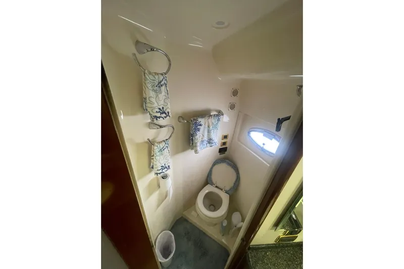 Sea Spirit Yacht Photos Pics Bathroom interior of 2004 Carver 570 Voyager Pilothouse yacht with towels and window.